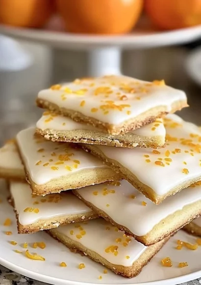 Delicious Cardamom Shortbread Cookies drizzled with orange glaze.