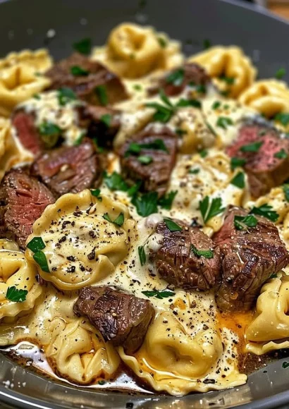 Cheesesteak Tortellini with rich provolone sauce garnished with herbs