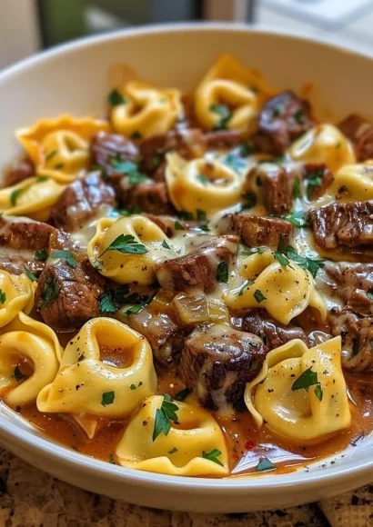Delicious Cheesesteak Tortellini in rich provolone sauce served in a bowl.