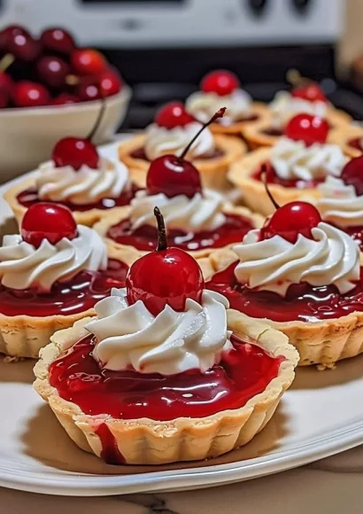 Delicious Cherry Delight Tarts topped with fresh cherries and cream
