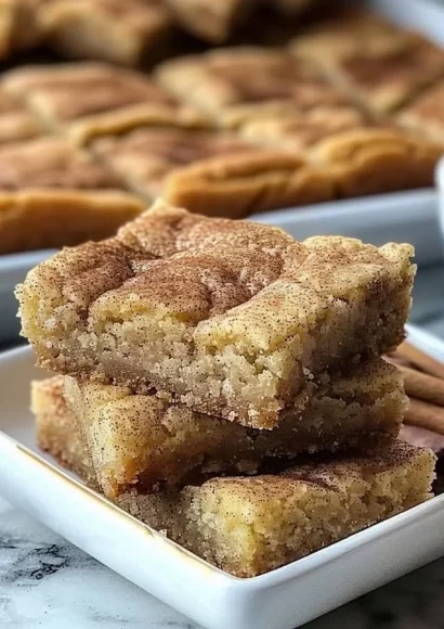 Chewy snickerdoodle cookie bars topped with cinnamon sugar