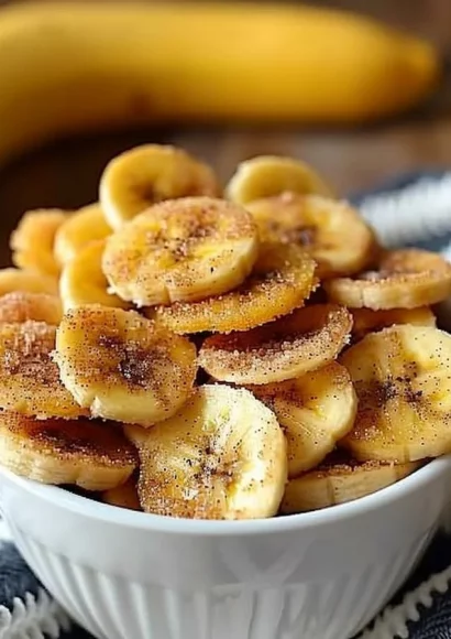Crunchy cinnamon-sugar air fryer banana chips on a wooden platter