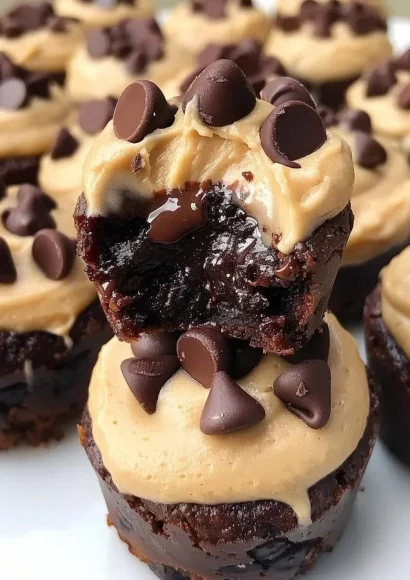 Mini chocolate chip brownie bites with cookie dough frosting on a plate