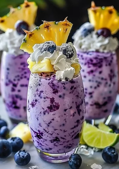 Delicious Pineapple Blueberry Frappuccino topped with whipped cream and fruits