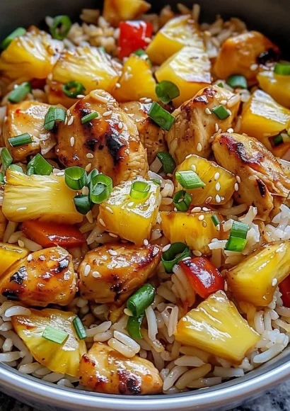 Delicious Pineapple Chicken and Rice served on a plate with colorful vegetables