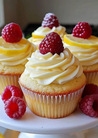 Delicious Raspberry Lemon Cupcakes topped with fresh raspberries and lemon zest