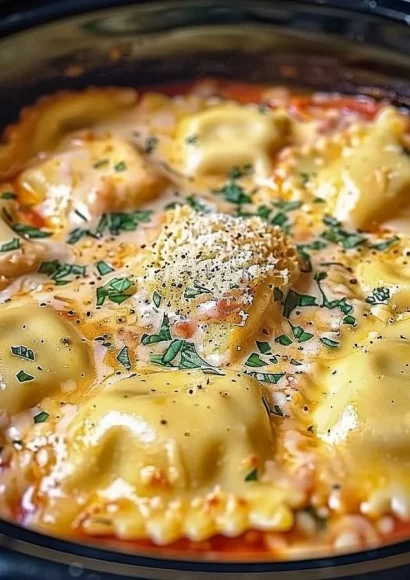 Bowl of slow cooker Italian ravioli garnished with herbs and cheese