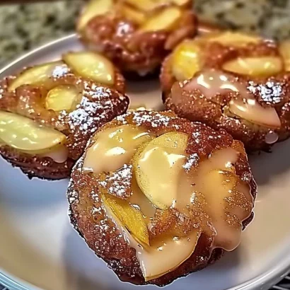 Warm baked apple fritters with cinnamon and apples on a wooden plate